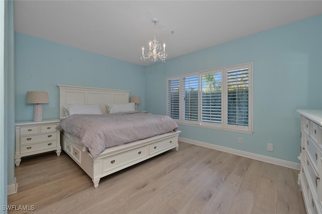 bedroom featuring a chandelier and light wood-type flooring