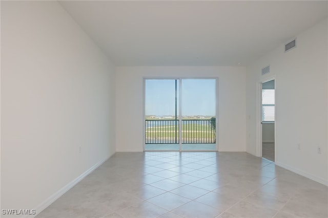 unfurnished room featuring light tile patterned floors