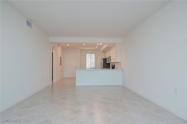 unfurnished living room featuring light tile patterned flooring