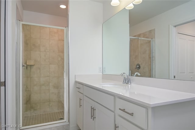 bathroom with vanity and a shower with shower door