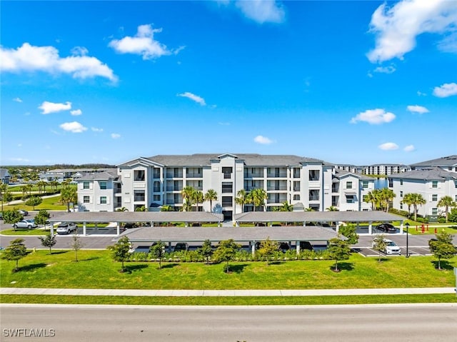 view of property with covered and uncovered parking