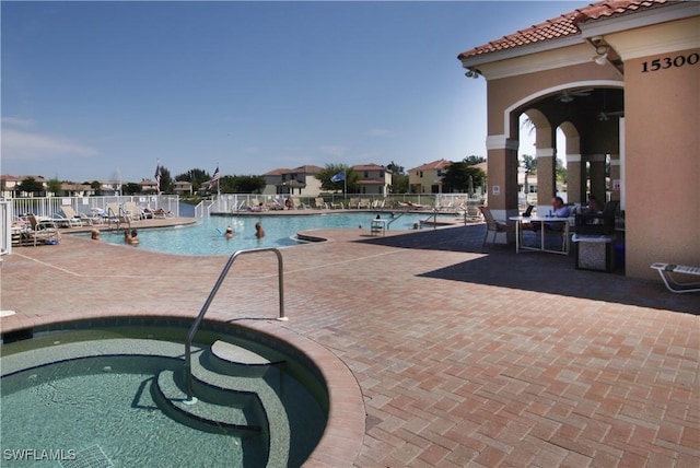 view of pool with a patio and a hot tub