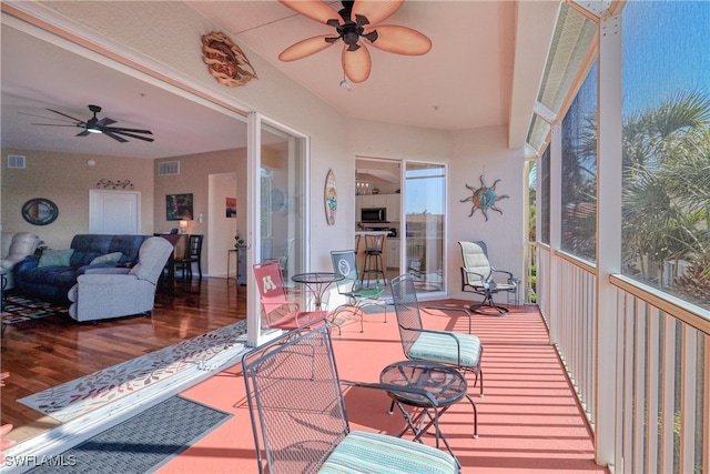 sunroom with a wealth of natural light and ceiling fan