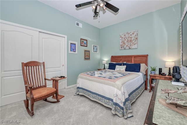 carpeted bedroom featuring ceiling fan and a closet