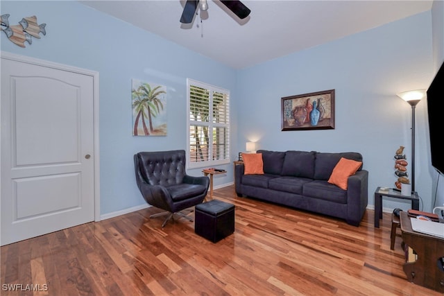 living room with ceiling fan and hardwood / wood-style floors