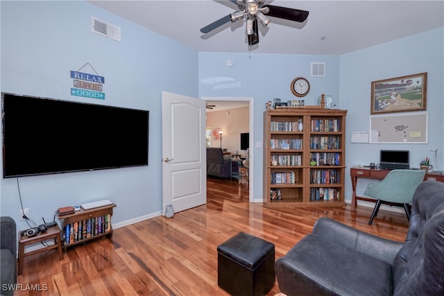 living room with hardwood / wood-style floors and ceiling fan