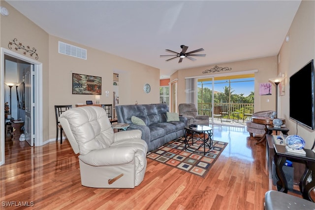 living room featuring wood-type flooring and ceiling fan