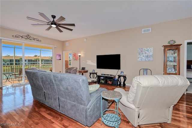 living room with ceiling fan and wood-type flooring