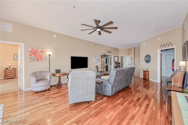 living room with ceiling fan and light hardwood / wood-style floors