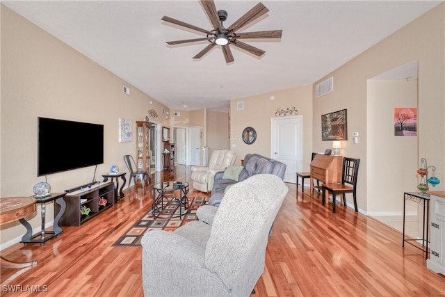 living room featuring ceiling fan and light hardwood / wood-style flooring