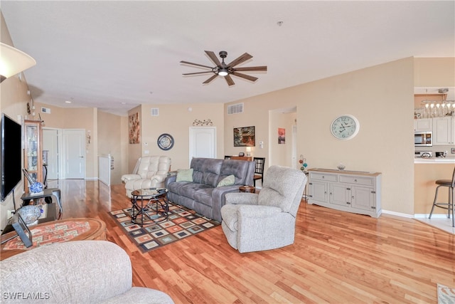 living room with ceiling fan and light hardwood / wood-style floors