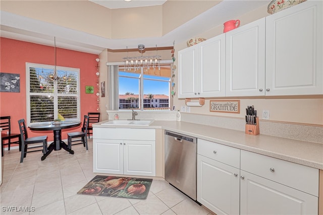 kitchen with white cabinets, dishwasher, sink, and decorative light fixtures