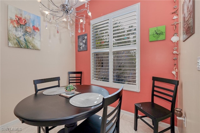 tiled dining room featuring a notable chandelier