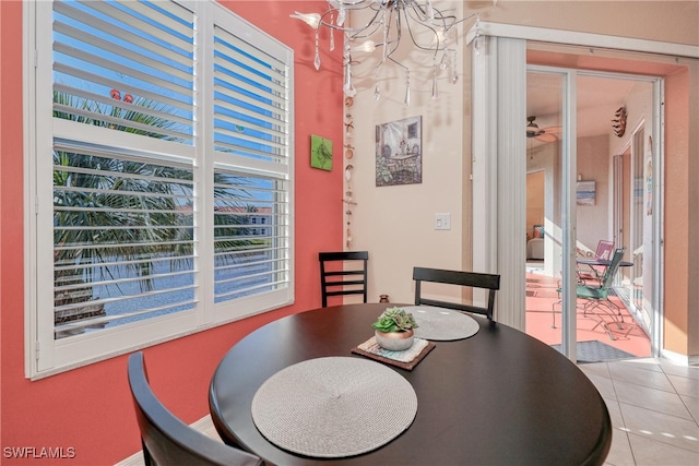 dining space with light tile patterned floors and a notable chandelier