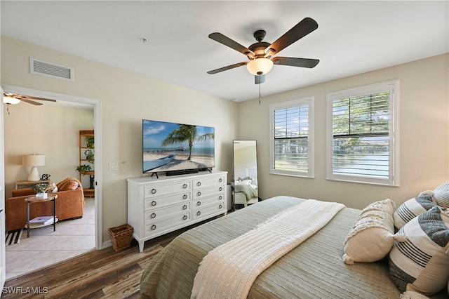 bedroom with ceiling fan and light hardwood / wood-style flooring