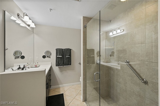 bathroom featuring tile patterned flooring, vanity, toilet, and walk in shower