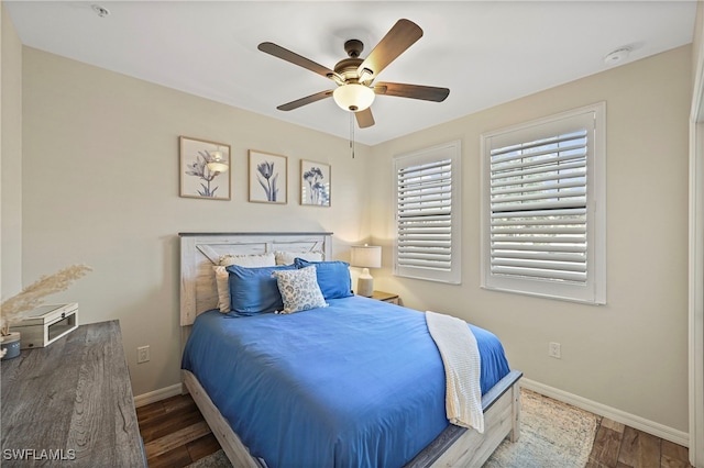 bedroom with ceiling fan and dark wood-type flooring