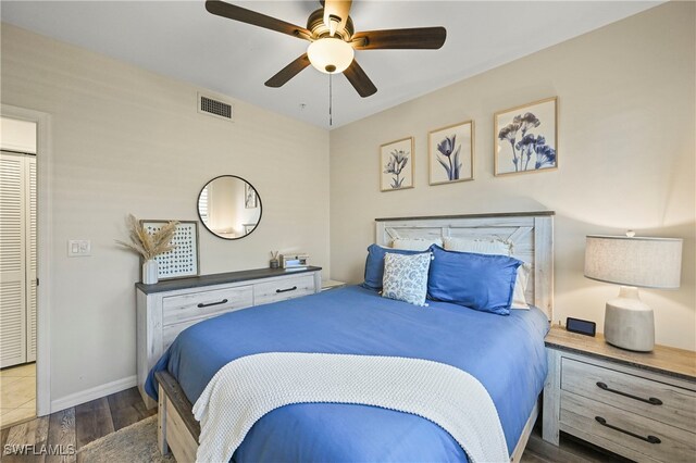 bedroom with dark hardwood / wood-style floors and ceiling fan