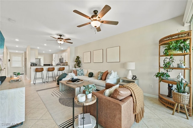 living room with ceiling fan and light tile patterned floors