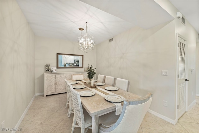 dining space featuring light tile patterned floors and an inviting chandelier