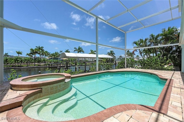 view of pool with a lanai, an in ground hot tub, and a water view