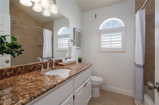 bathroom with vanity, vaulted ceiling, tile patterned flooring, toilet, and walk in shower