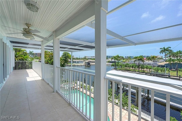 balcony with a water view and ceiling fan