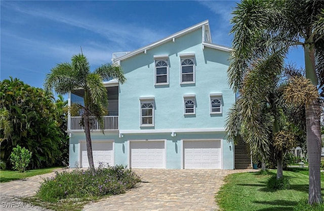 view of front facade with a garage and a balcony