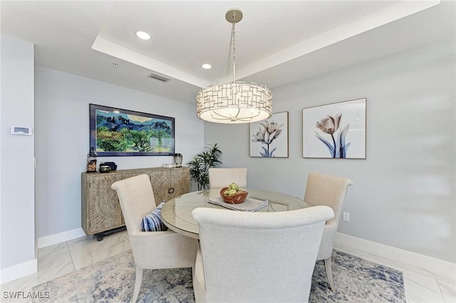 dining room with a tray ceiling