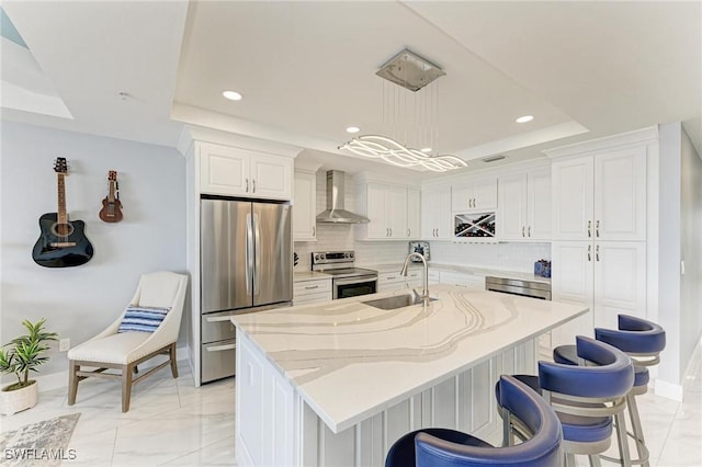 1425 Park Beach Cir Unit 149, Punta Gorda, FL 33950 - kitchen featuring stainless steel appliances, a raised ceiling, a sink, wall chimney exhaust hood, and tasteful backsplash