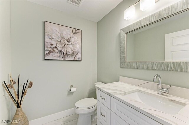 1425 Park Beach Cir Unit 149, Punta Gorda, FL 33950 - bathroom featuring toilet, baseboards, vanity, and marble look tiles