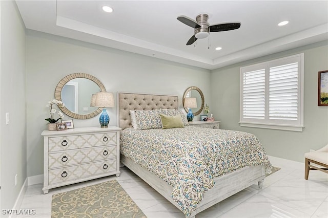 bedroom featuring a tray ceiling and ceiling fan