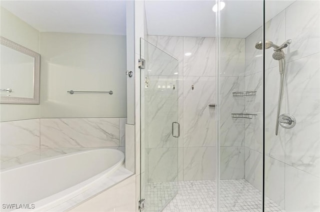 bathroom featuring separate shower and tub