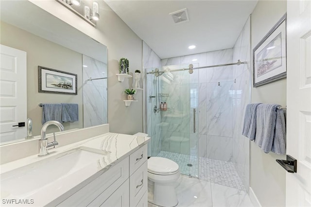 bathroom featuring a shower with door, vanity, and toilet