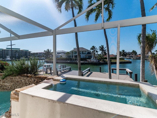 view of swimming pool with a water view and a dock