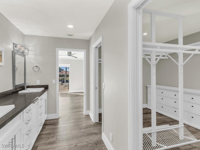 bathroom featuring hardwood / wood-style floors, vanity, and ceiling fan