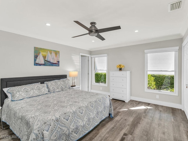 bedroom with ceiling fan, crown molding, and hardwood / wood-style flooring