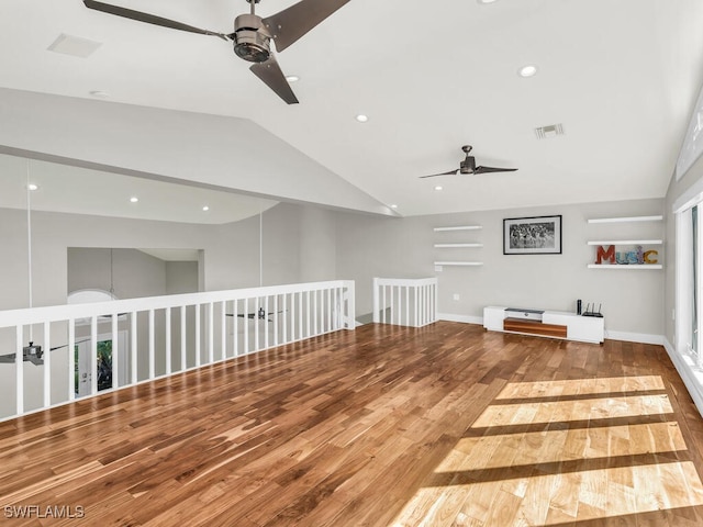 interior space featuring ceiling fan, wood-type flooring, and vaulted ceiling