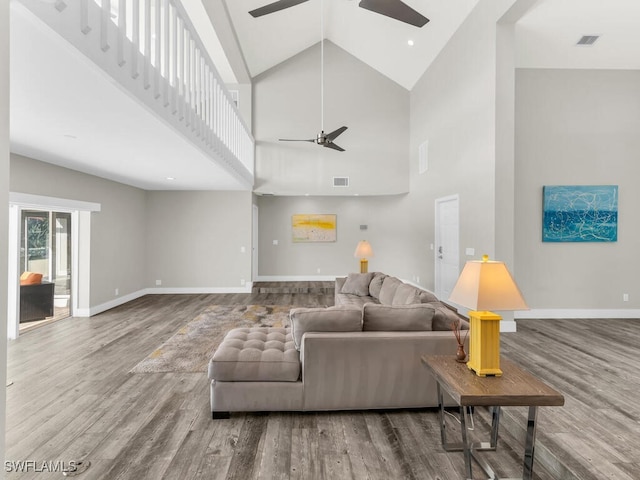 living room featuring high vaulted ceiling and hardwood / wood-style flooring