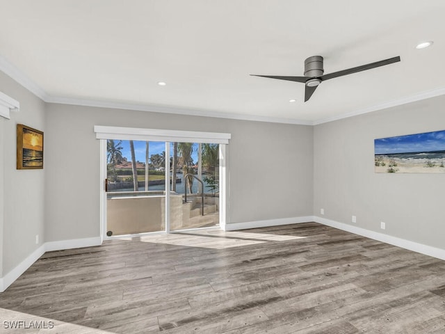 spare room featuring hardwood / wood-style floors, ceiling fan, and crown molding