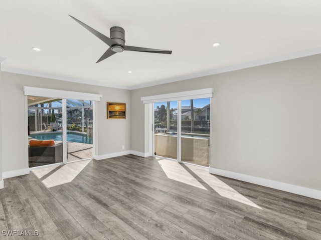 spare room with wood-type flooring, ceiling fan, and ornamental molding