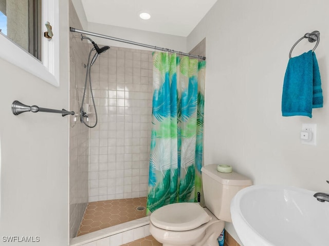 bathroom featuring tile patterned floors, a shower with curtain, toilet, and sink