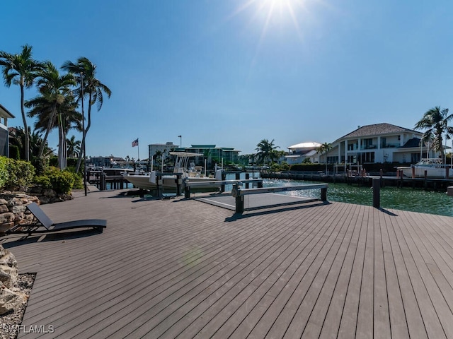 wooden deck featuring a water view and a dock