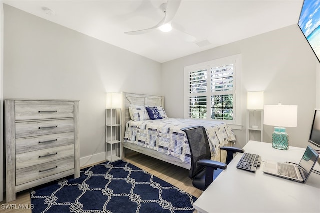 bedroom with ceiling fan and hardwood / wood-style flooring