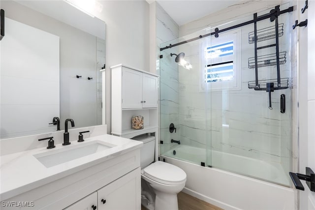 full bathroom with toilet, combined bath / shower with glass door, and vanity