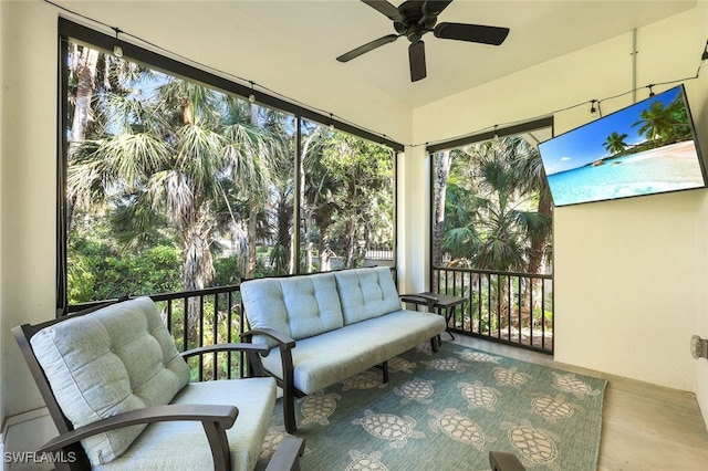 sunroom / solarium featuring ceiling fan