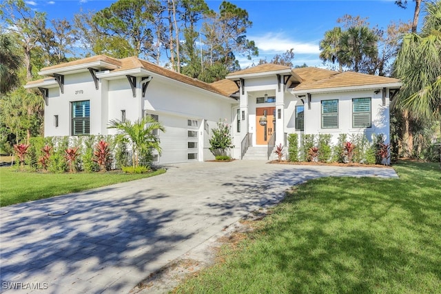 view of front facade with a front lawn and a garage