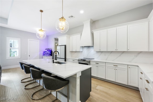 kitchen with white cabinetry, hanging light fixtures, custom range hood, and stainless steel electric range oven