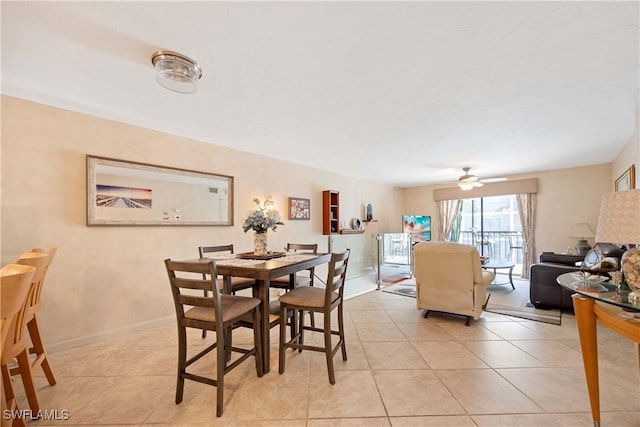 tiled dining area featuring ceiling fan