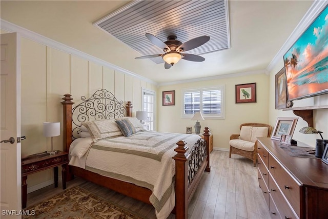 bedroom featuring ceiling fan, light wood-type flooring, and ornamental molding